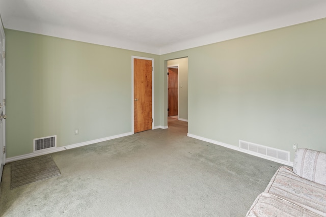 unfurnished living room with baseboards, visible vents, and carpet floors