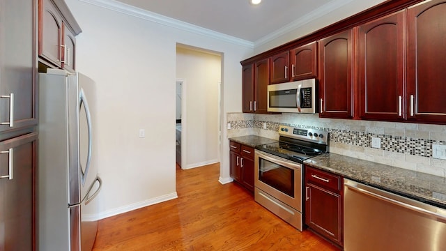 kitchen with stainless steel appliances, tasteful backsplash, dark brown cabinets, and crown molding