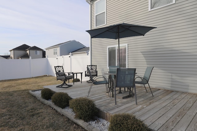 wooden deck with a yard, fence private yard, and outdoor dining space