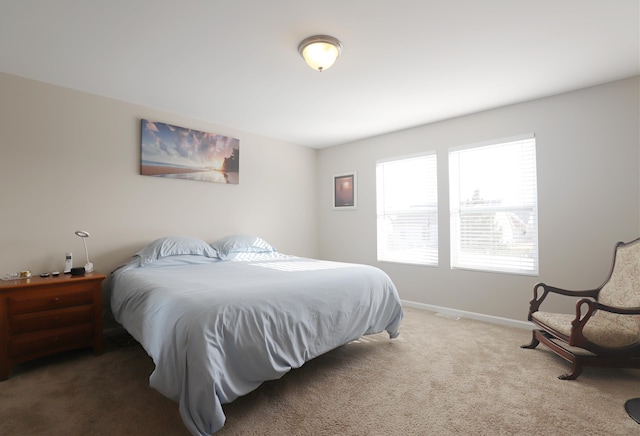 carpeted bedroom with baseboards