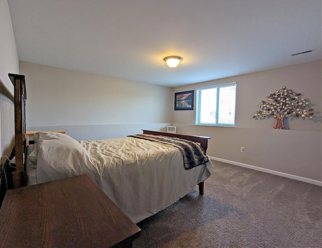 bedroom featuring baseboards, visible vents, and dark carpet