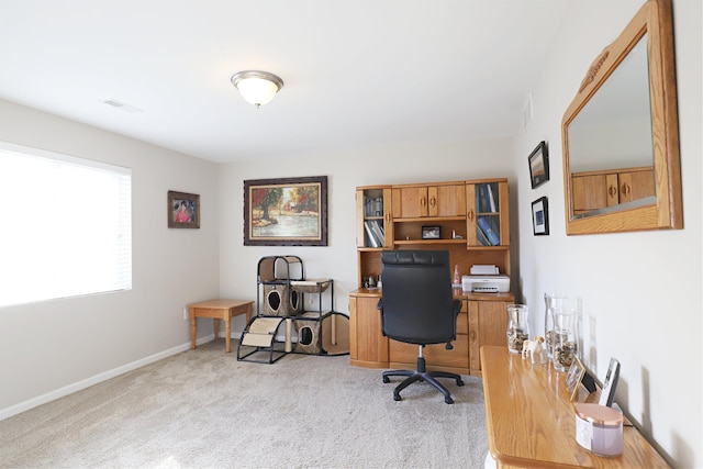 carpeted office space featuring visible vents and baseboards