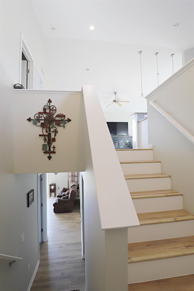 staircase featuring recessed lighting, wood finished floors, and ceiling fan