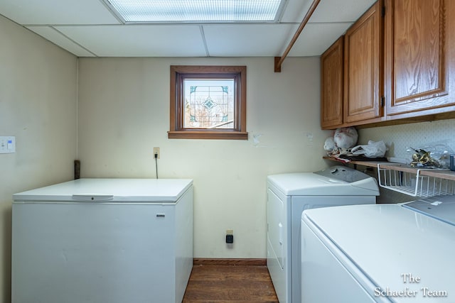 clothes washing area featuring cabinet space, separate washer and dryer, and dark wood finished floors