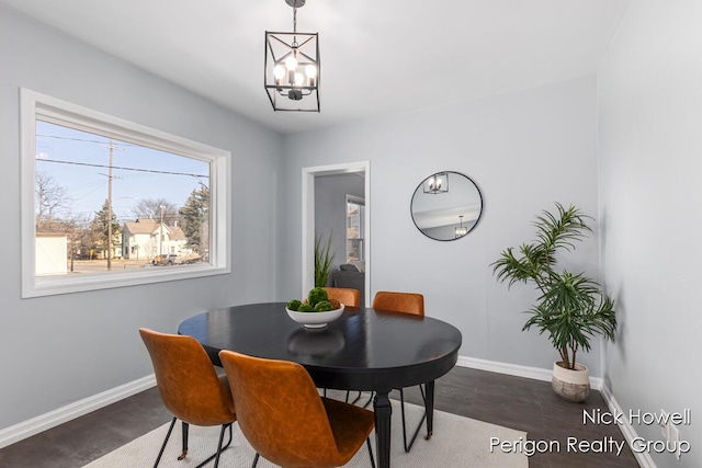 dining area with a notable chandelier and baseboards