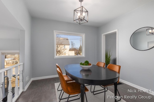 dining room with baseboards, an inviting chandelier, and dark wood finished floors