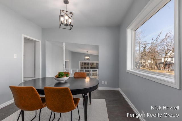 dining space featuring dark wood-style floors, baseboards, and a chandelier