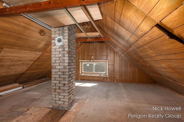 bonus room with wood walls, an AC wall unit, and vaulted ceiling