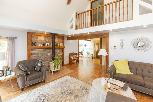 15797 Hillside Dr, Vandalia, MI 49095 - living room with a wood stove, a towering ceiling, and wood finished floors