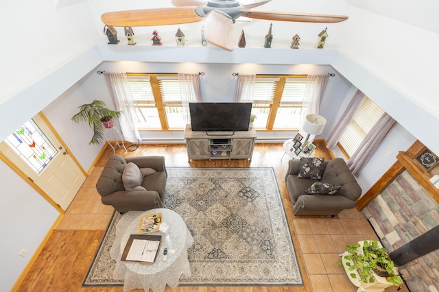 15797 Hillside Dr, Vandalia, MI 49095 - tiled living room featuring a wealth of natural light, baseboards, and a ceiling fan