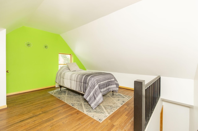 15797 Hillside Dr, Vandalia, MI 49095 - bedroom with vaulted ceiling, baseboards, and hardwood / wood-style flooring
