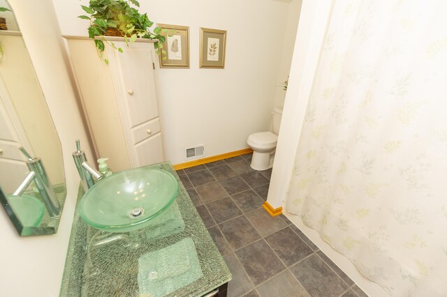 15797 Hillside Dr, Vandalia, MI 49095 - full bathroom with vanity, a shower with shower curtain, baseboards, visible vents, and toilet