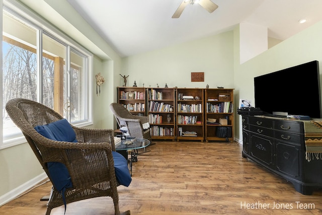 sitting room featuring a wealth of natural light, lofted ceiling, and wood finished floors