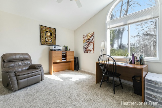 carpeted office with lofted ceiling and ceiling fan