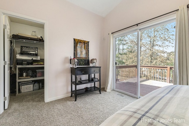 carpeted bedroom featuring visible vents, a walk in closet, baseboards, a closet, and access to outside