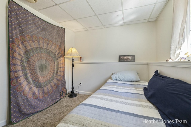 bedroom featuring carpet flooring, a paneled ceiling, and baseboards