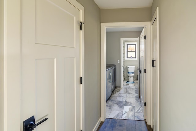 corridor featuring washer and clothes dryer