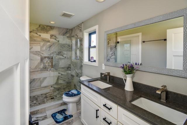 bathroom featuring a sink, visible vents, toilet, and a shower stall