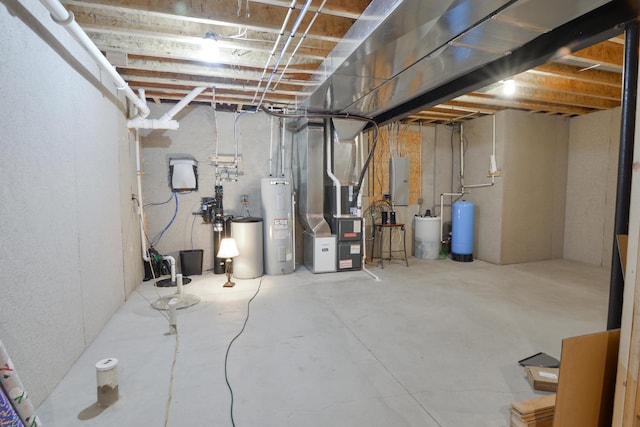 unfinished basement with heating unit and electric water heater