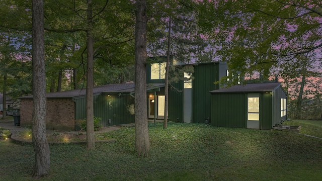 back of house featuring an outbuilding and a storage shed