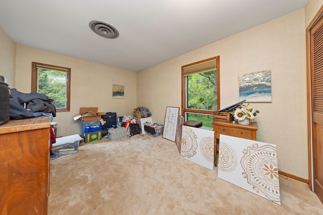 interior space featuring visible vents, a healthy amount of sunlight, and carpet flooring