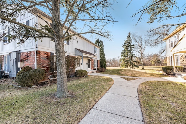 view of home's exterior featuring a yard and brick siding