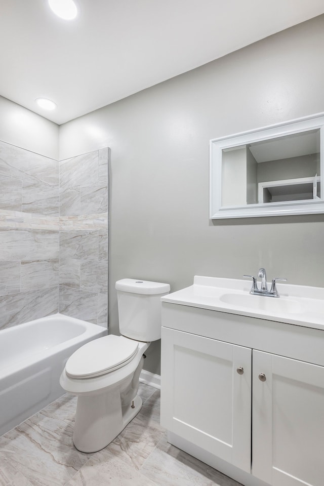 bathroom featuring toilet, marble finish floor, and vanity