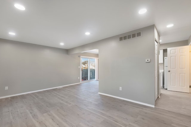 spare room with visible vents, recessed lighting, light wood-type flooring, and baseboards