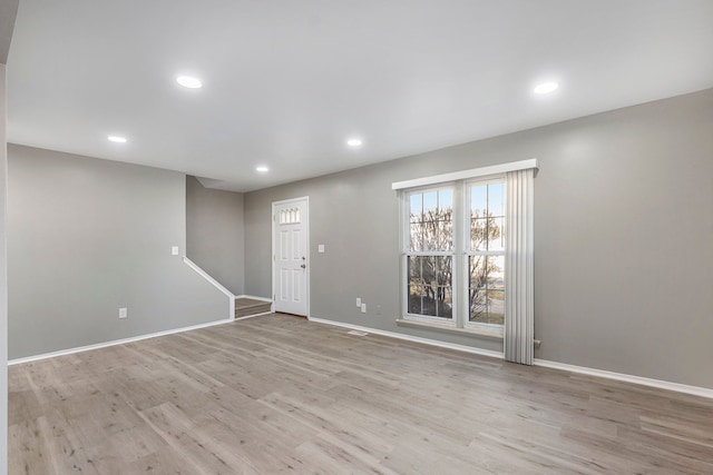 interior space featuring recessed lighting, light wood-style flooring, and baseboards