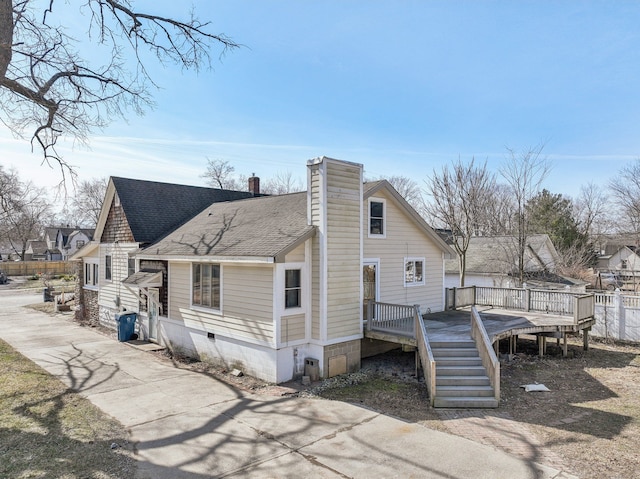 back of house with stairway, a wooden deck, a shingled roof, a chimney, and crawl space