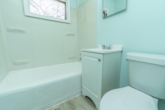 full bathroom with toilet, shower / washtub combination, wood finished floors, and vanity