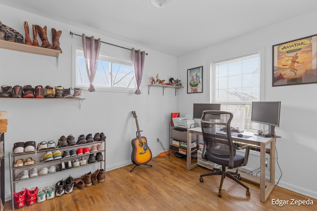 home office featuring plenty of natural light, wood finished floors, and baseboards