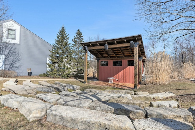 exterior space featuring board and batten siding and an outdoor structure