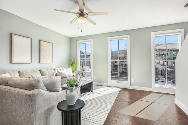 living room featuring plenty of natural light, baseboards, and hardwood / wood-style floors