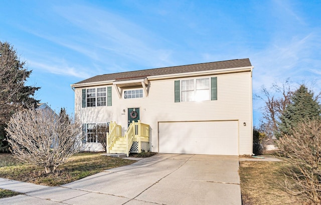 split foyer home featuring a garage and concrete driveway