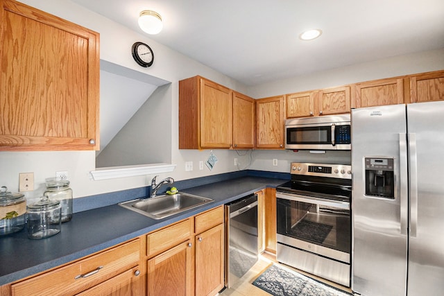 kitchen featuring a sink, dark countertops, recessed lighting, and stainless steel appliances