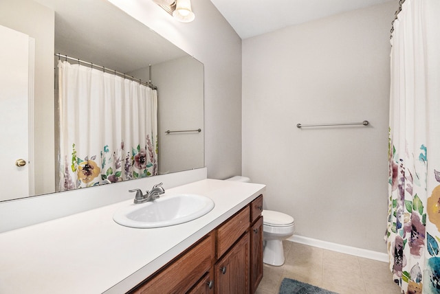 bathroom featuring vanity, a shower with shower curtain, baseboards, tile patterned floors, and toilet