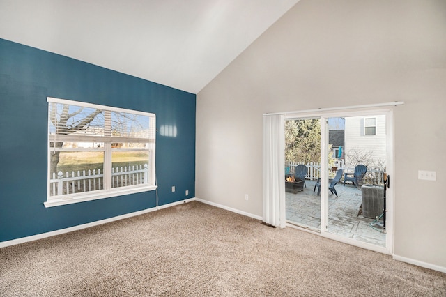 unfurnished room featuring high vaulted ceiling, baseboards, and carpet