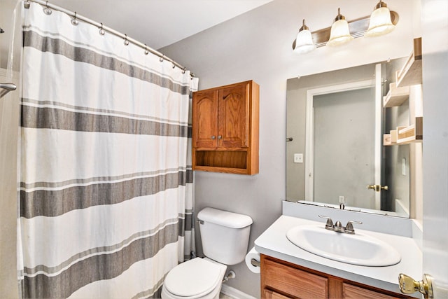 bathroom with vanity, a shower with shower curtain, and toilet