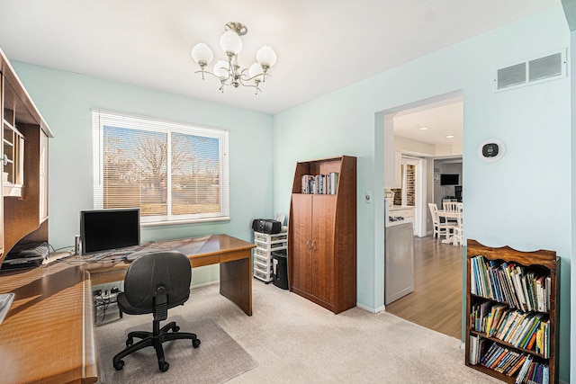 office featuring a chandelier, visible vents, and light carpet