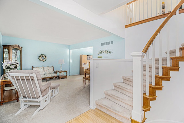 staircase featuring visible vents and carpet floors