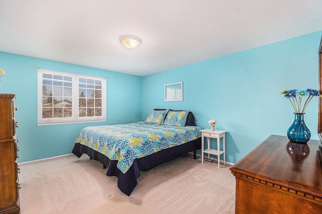 carpeted bedroom with baseboards