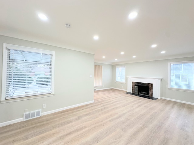 unfurnished living room with recessed lighting, visible vents, baseboards, and light wood-style floors
