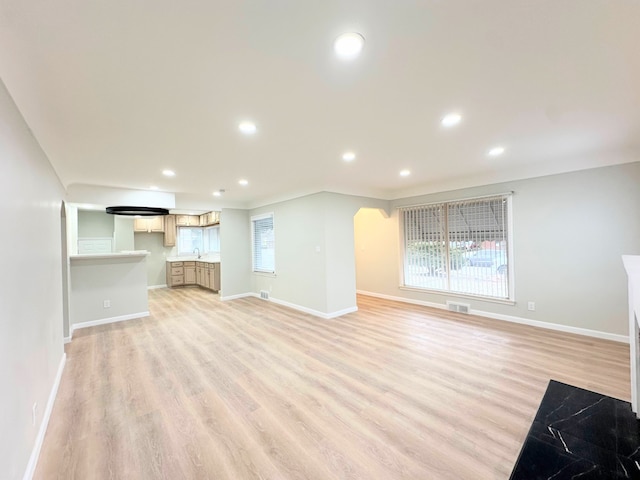 unfurnished living room featuring visible vents, recessed lighting, light wood-type flooring, and baseboards