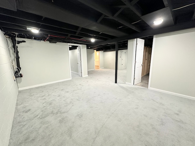 finished basement featuring carpet flooring and baseboards