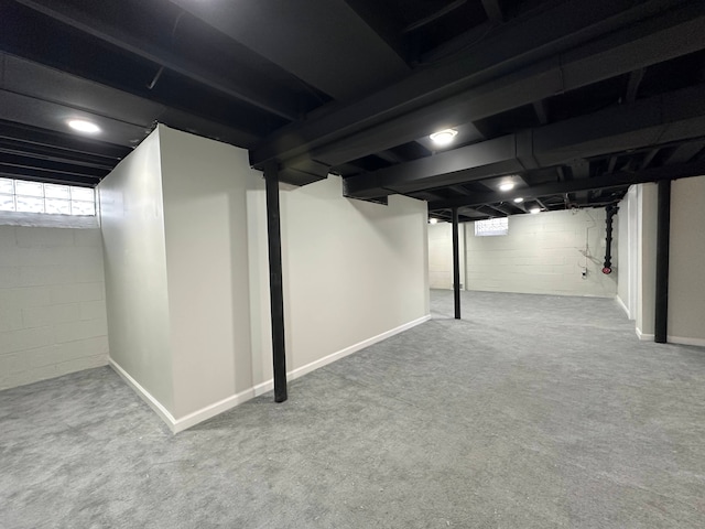 basement with carpet flooring and baseboards