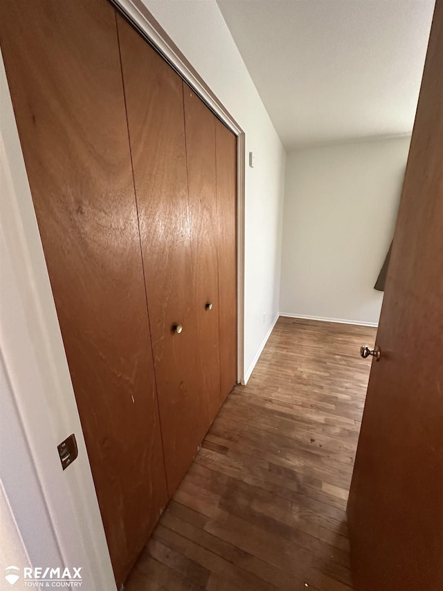 hall with wood finished floors and baseboards