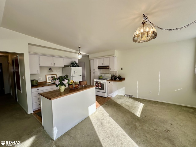 kitchen with under cabinet range hood, wood counters, white appliances, white cabinets, and lofted ceiling