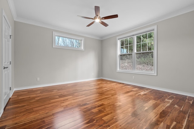 spare room with crown molding, baseboards, wood-type flooring, and ceiling fan