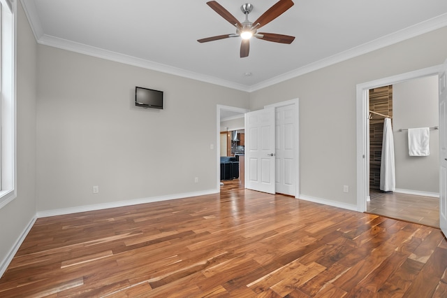 unfurnished bedroom featuring ornamental molding, baseboards, and wood finished floors